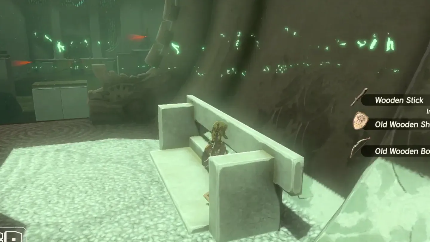 Link picking up the starter weapons from the stone bench