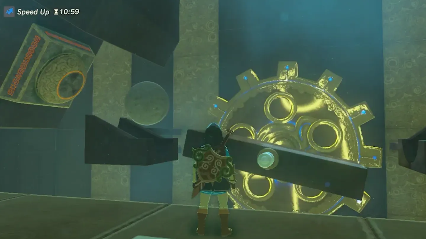 A boulder dropping past a large spinning gear with a platform bar across it