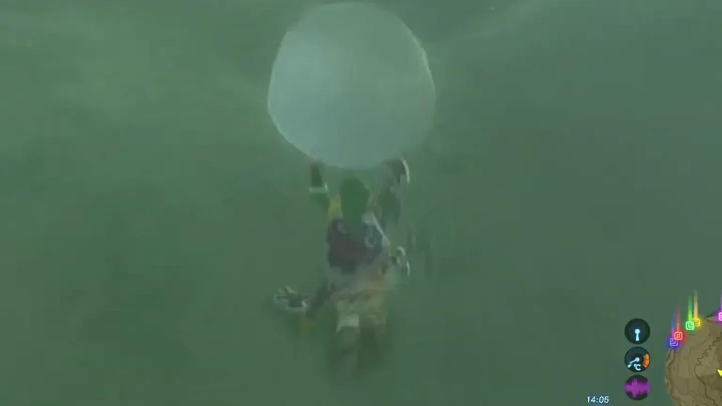 Link carrying a large snowball over his head in a blizzard