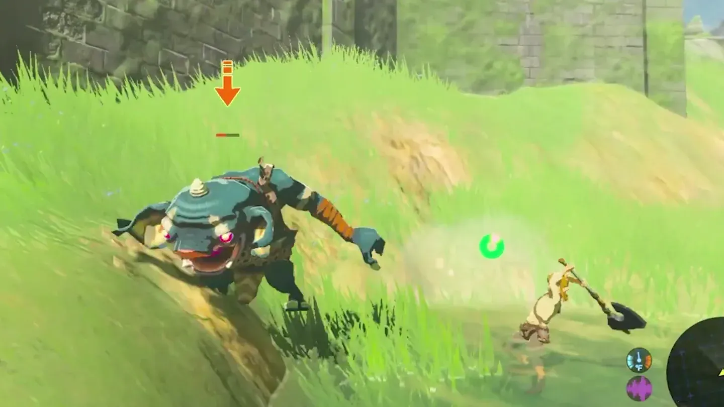 A Blue Bokoblin with dark blue skin and a pink snout lunging out of the grass at Link