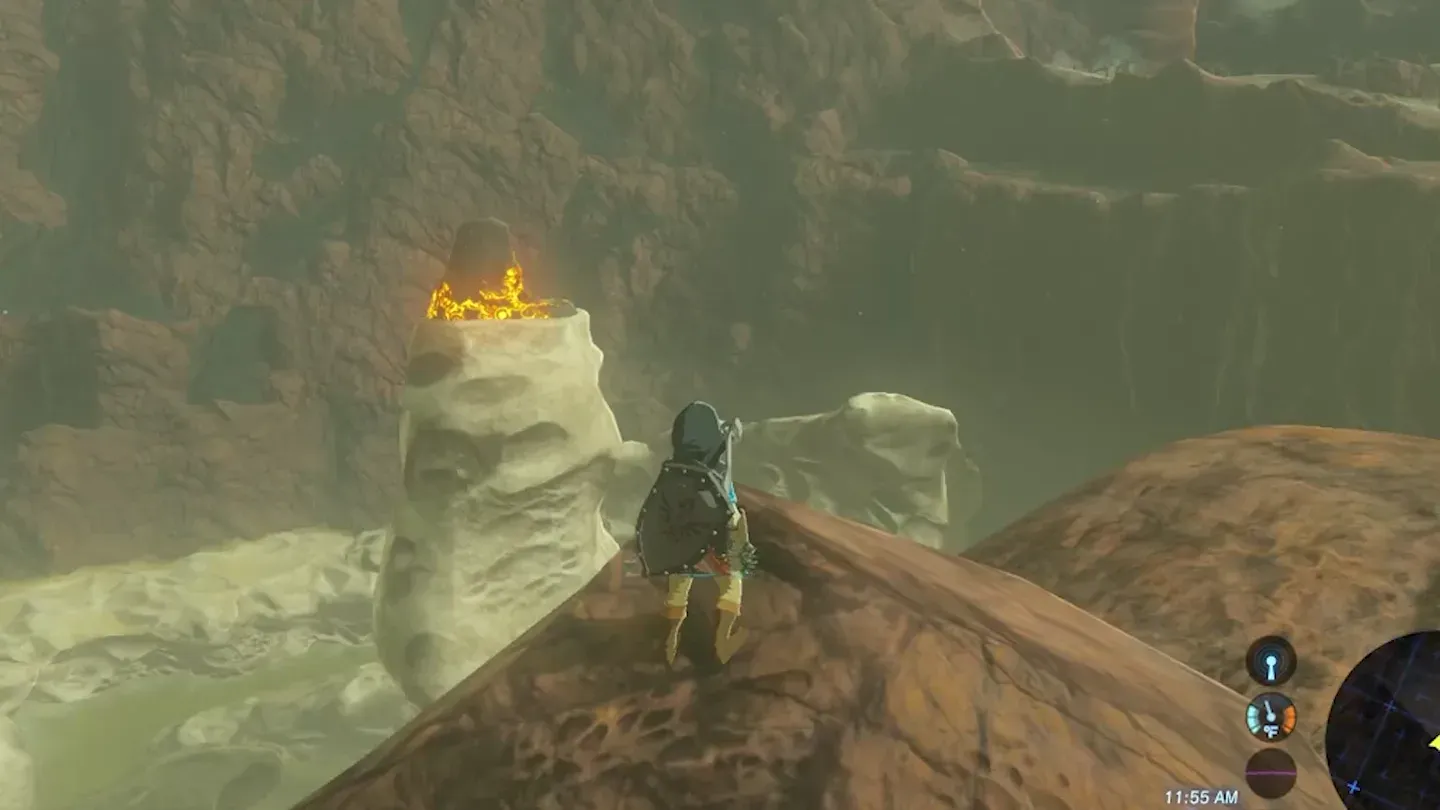 A tall pale rock spire rising from the lake