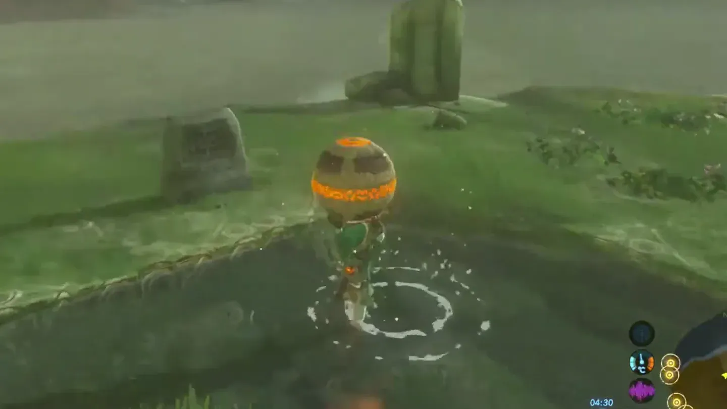 Link lifting the glowing Ancient Orb out of a shallow pool by the ruins