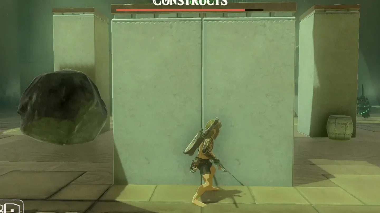 Link hiding behind a stone block while a Construct patrols