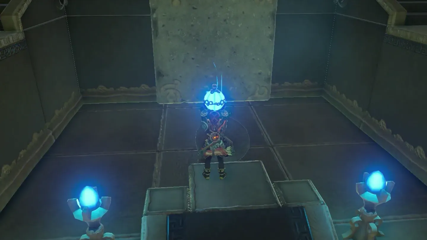 Link on the lower floor holding a round Remote Bomb in front of the block's funnel