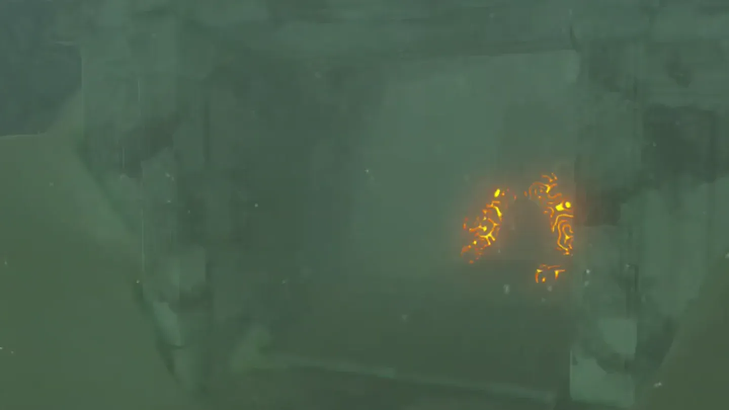 The shrine's orange glow behind the broken stone door frame