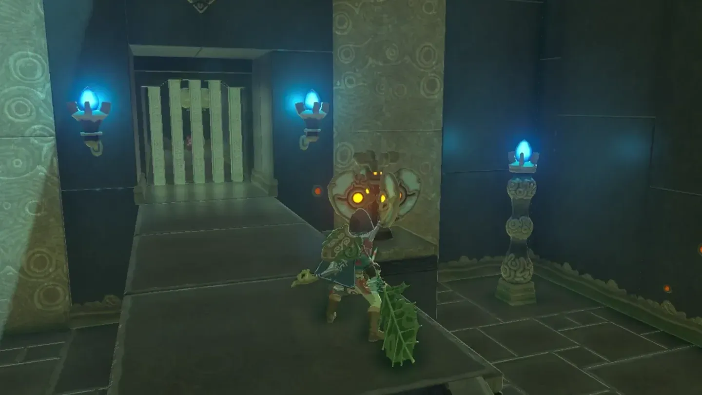 Link holding the Korok Leaf beside a fan-shaped Wind Switch next to the gate