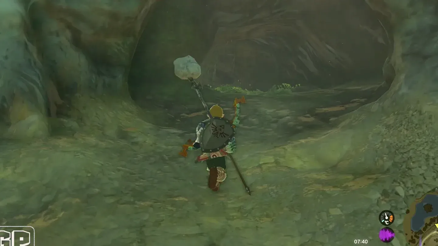 Link walking toward the dark cave mouth