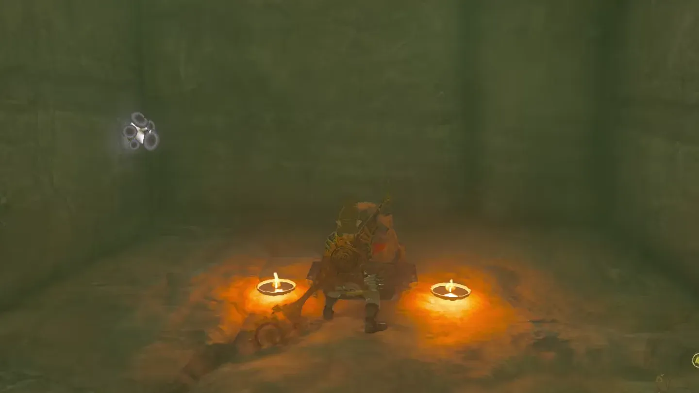 Link at a frog statue with two candles inside the mine