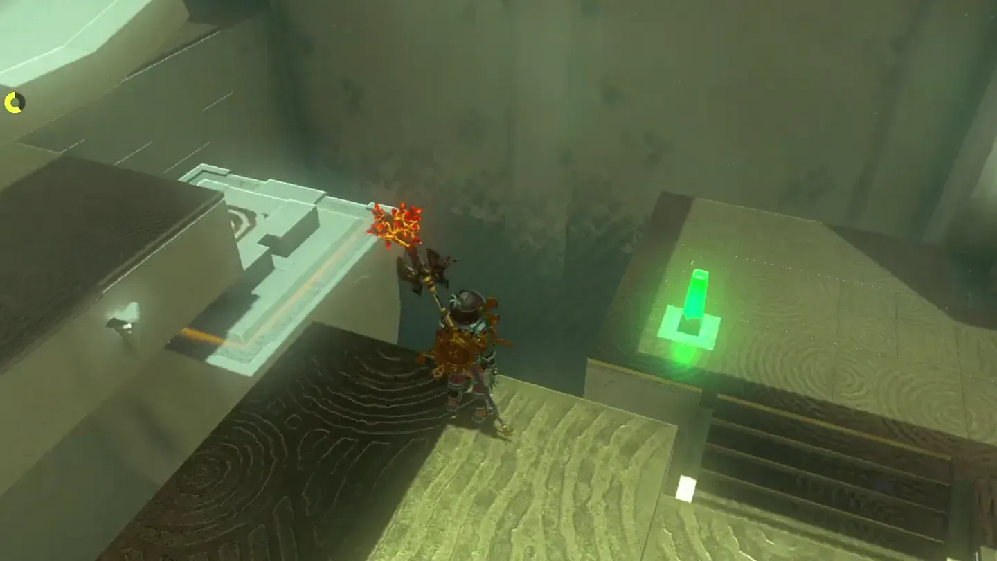 The struck pedestal glowing green on the lower level