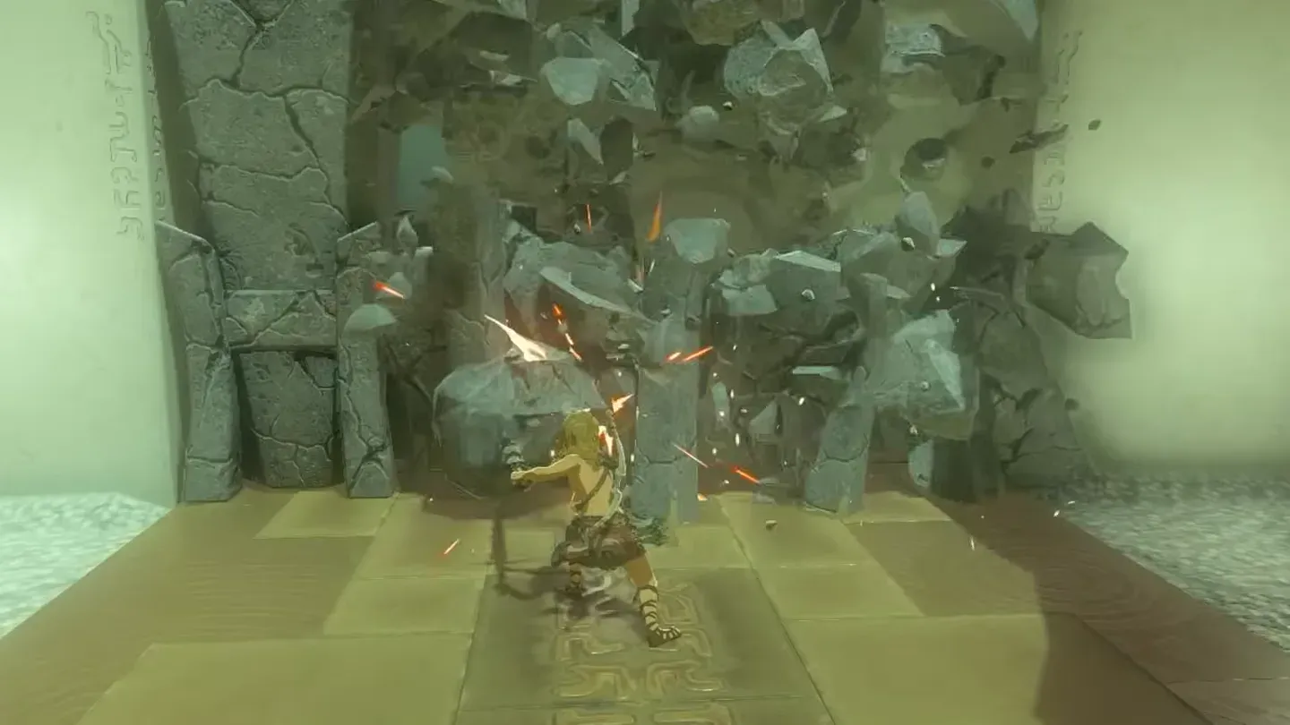 The cracked wall bursting apart under the boulder hammer