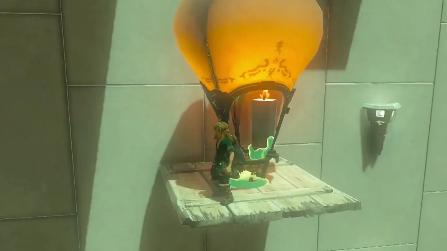 Link standing on the platform as the balloon carries it up past the lit pillar