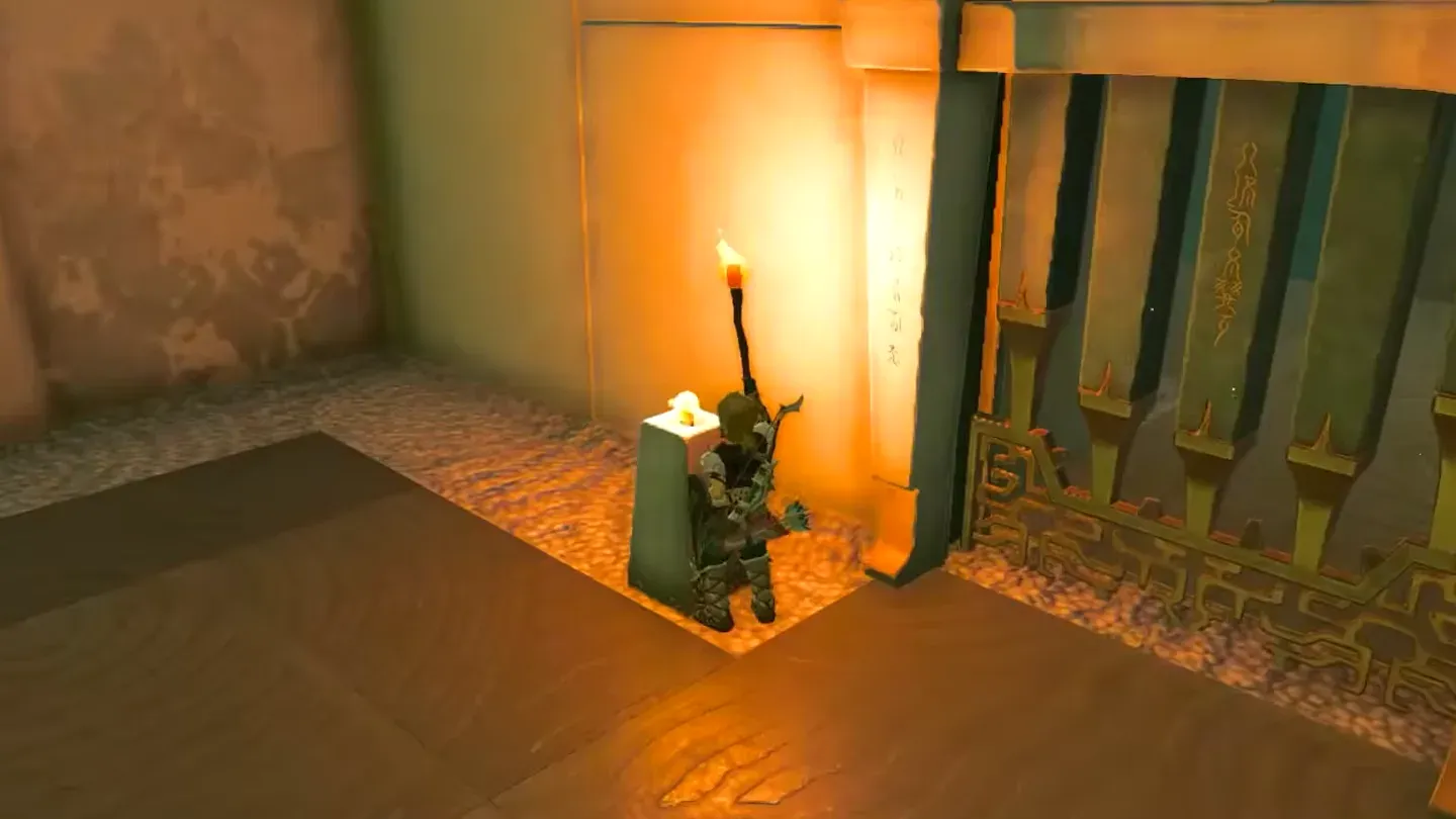 Link lighting a pillar beside the gate with his torch