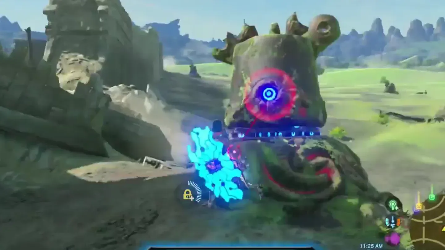 A moss-covered, half-buried Decayed Guardian with a blue eye ringed in red, Link attacking its side