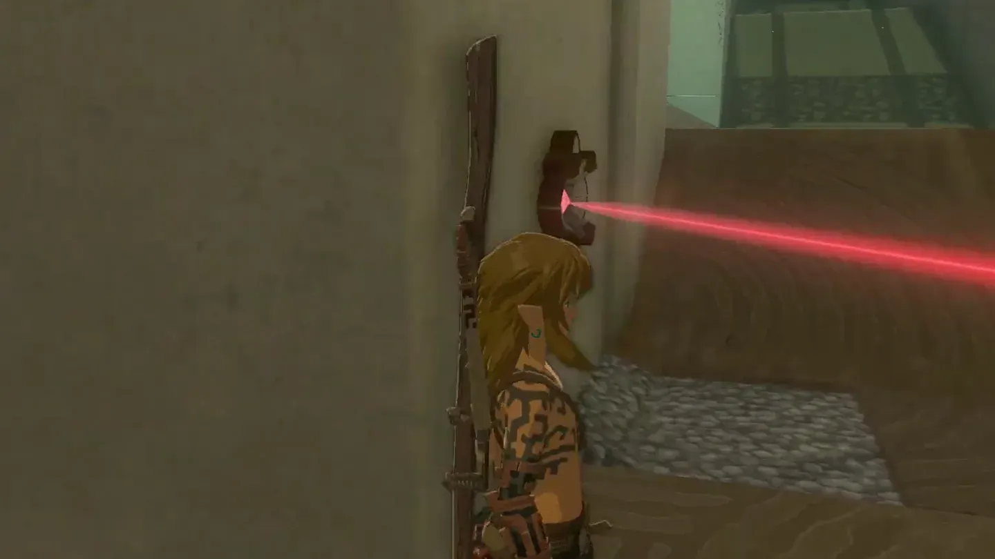 Link pressed against the wall beside a laser emitter