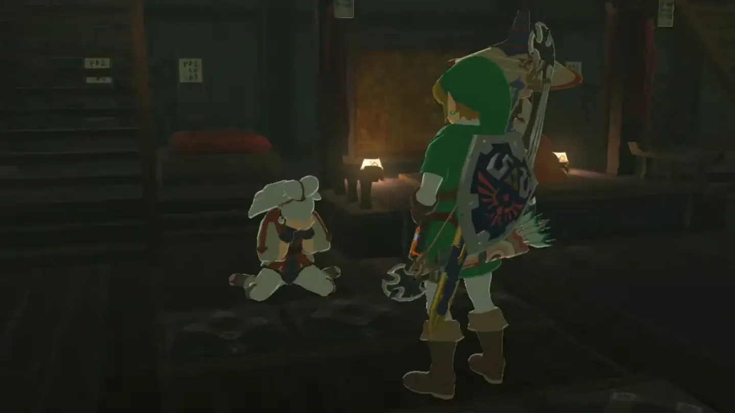 Link standing beside Paya kneeling in Impa's house