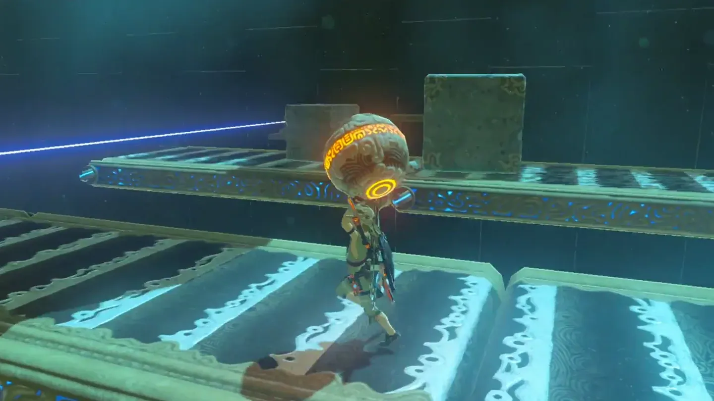 Link carrying the orb across the belts between laser beams