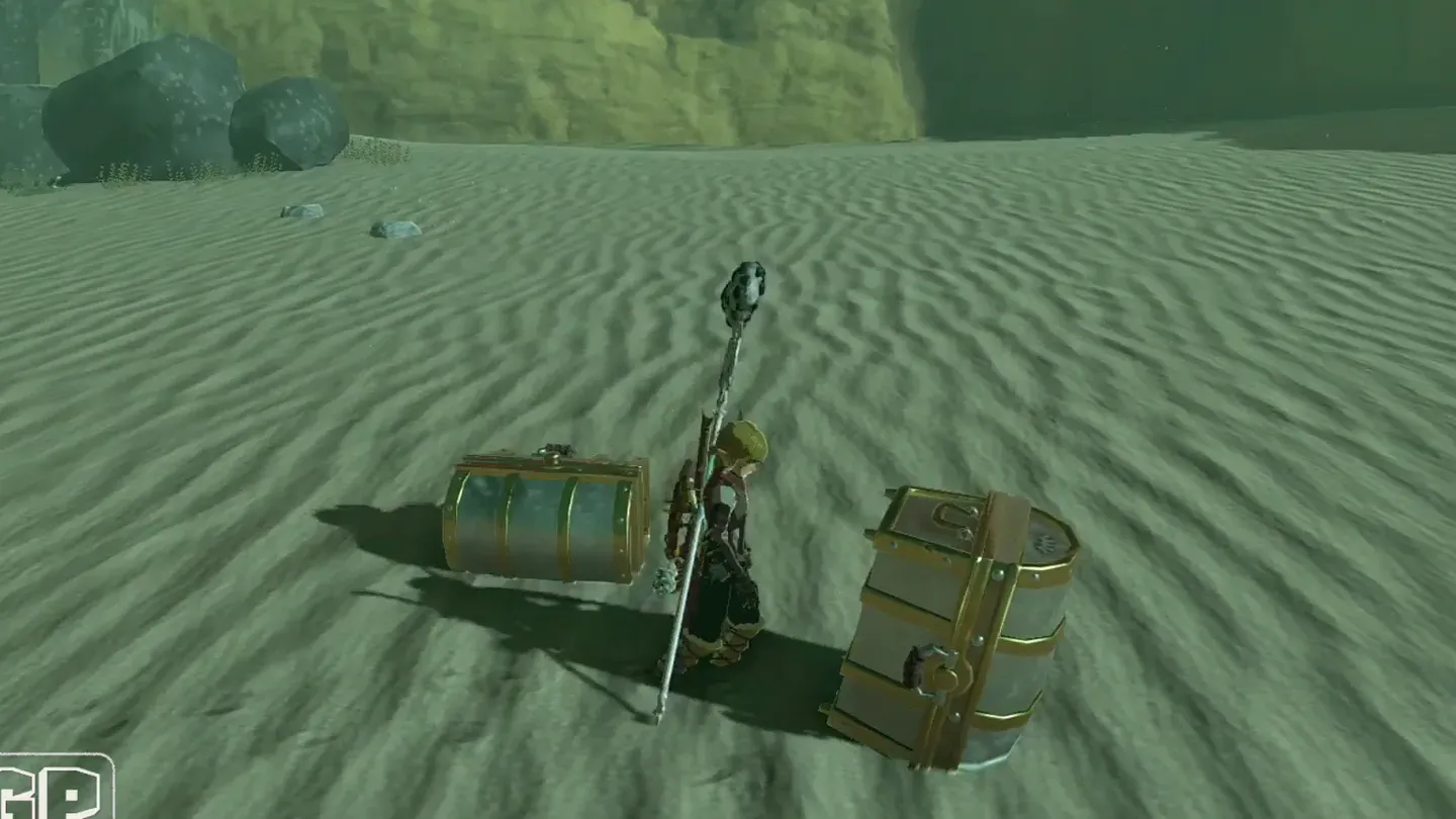 Link standing between two treasure chests on the sand