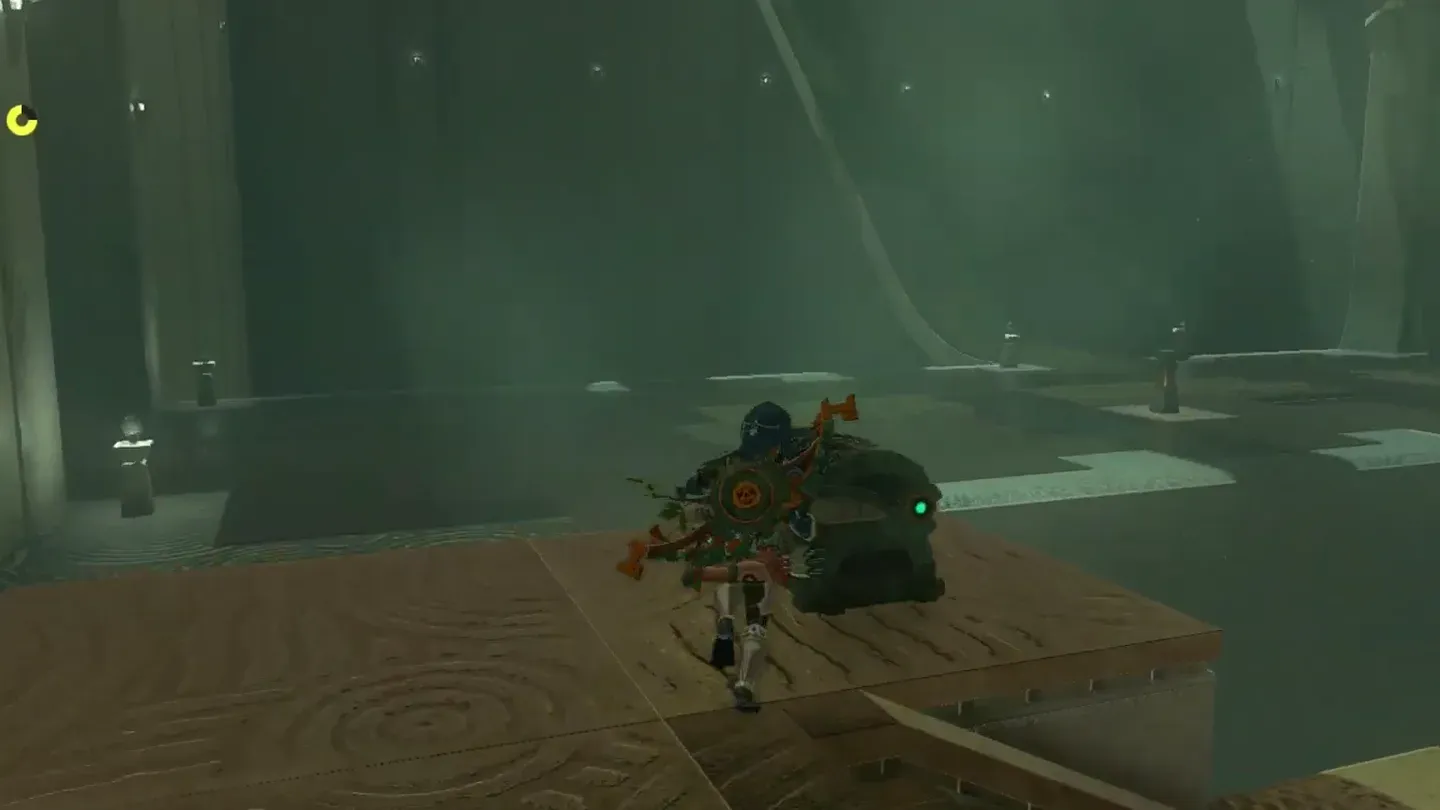 Link crouching at the open chest on the ledge