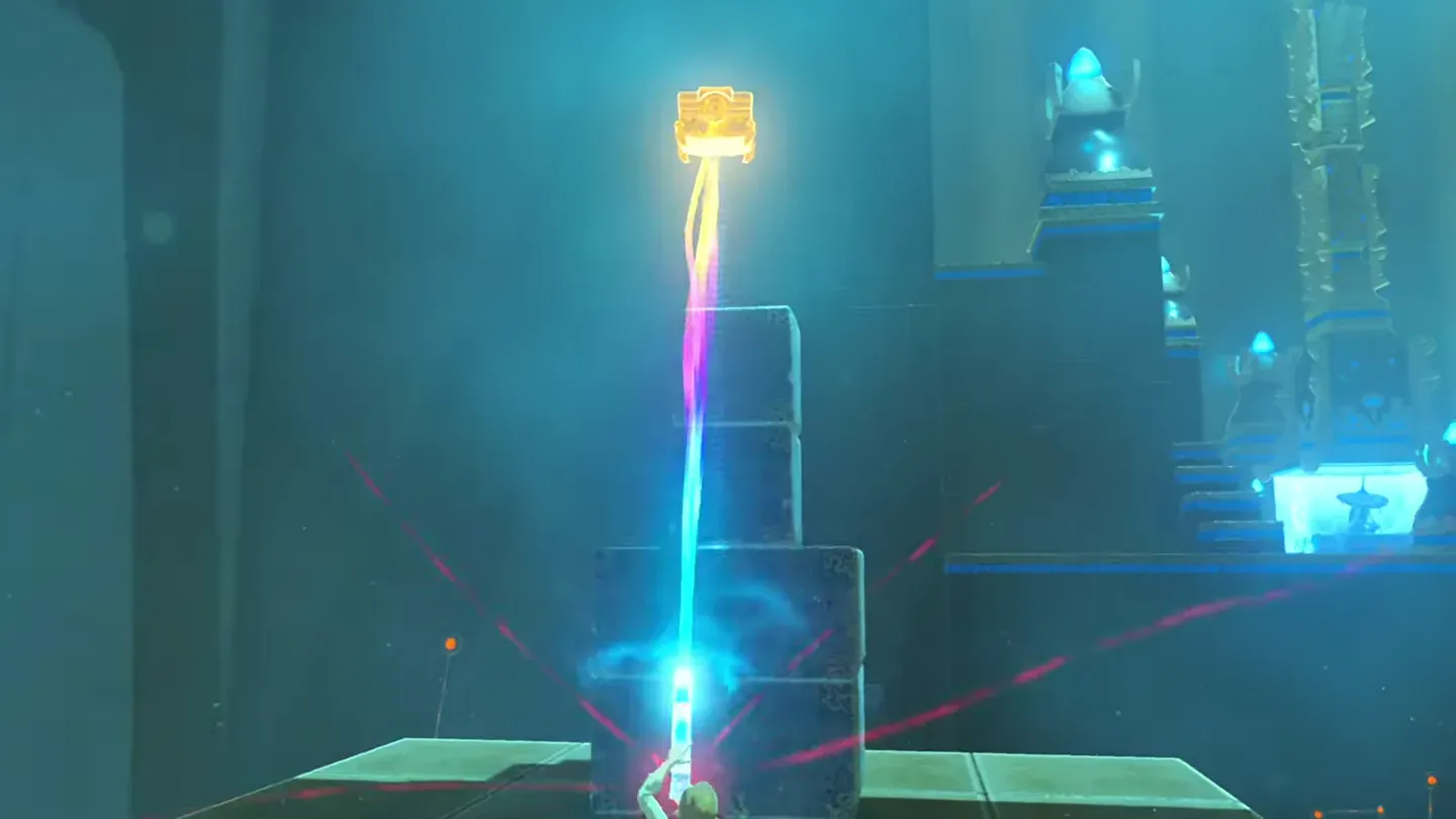 Link pulling the metal chest down from the top of the stone stack