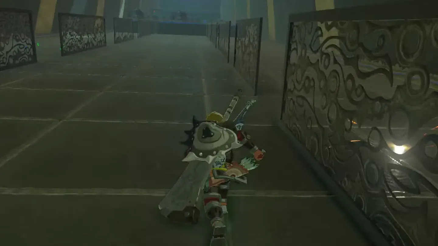 Link climbing right beside the patterned metal fence