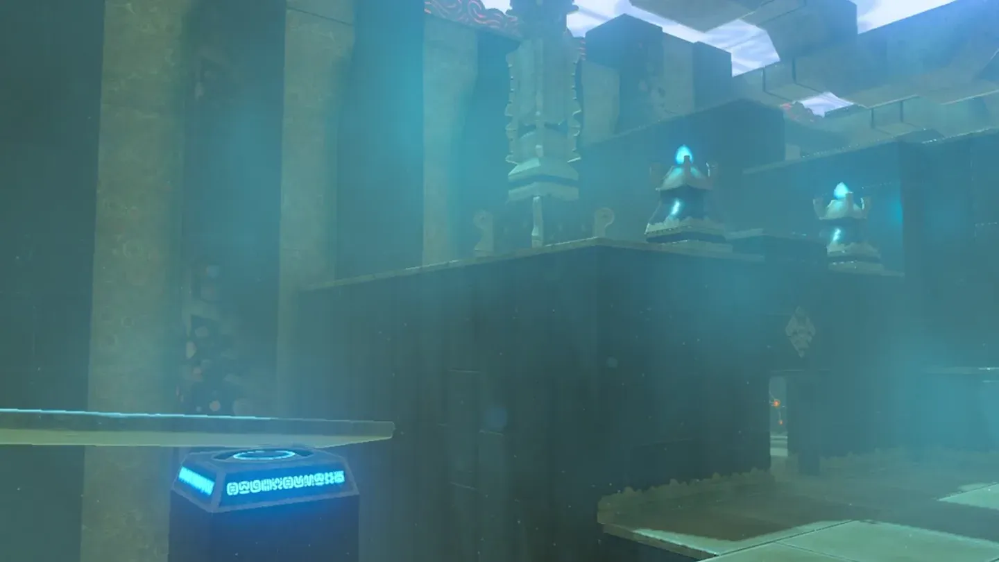 The large stone slab lying flat on a glowing blue switch