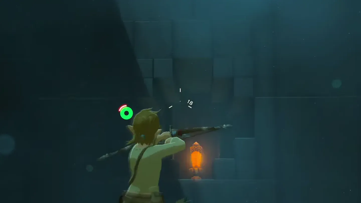 Link aiming a bow at an orange crystal in a dark alcove
