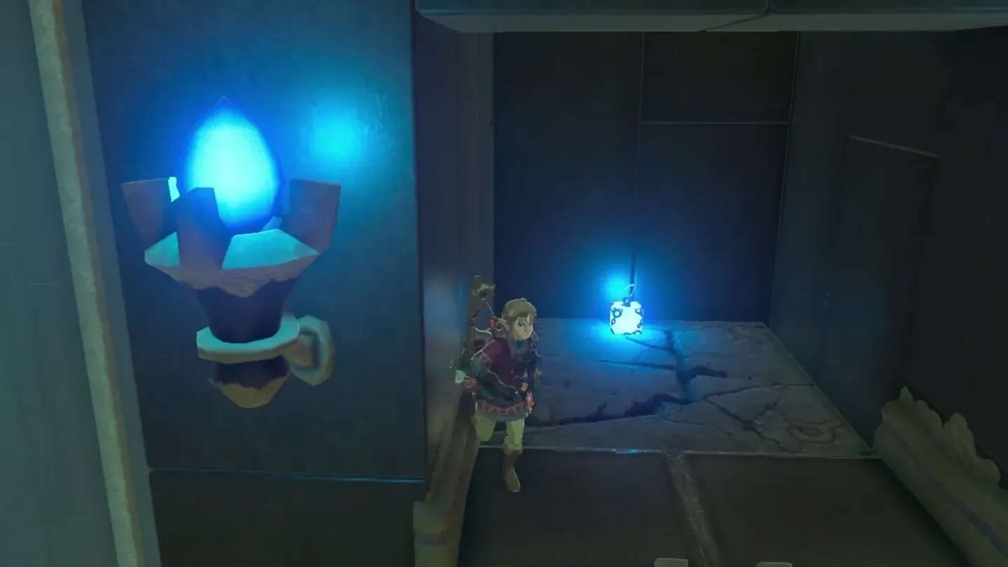 A glowing Remote Bomb lying on the cracked floor inside the tower's indentation
