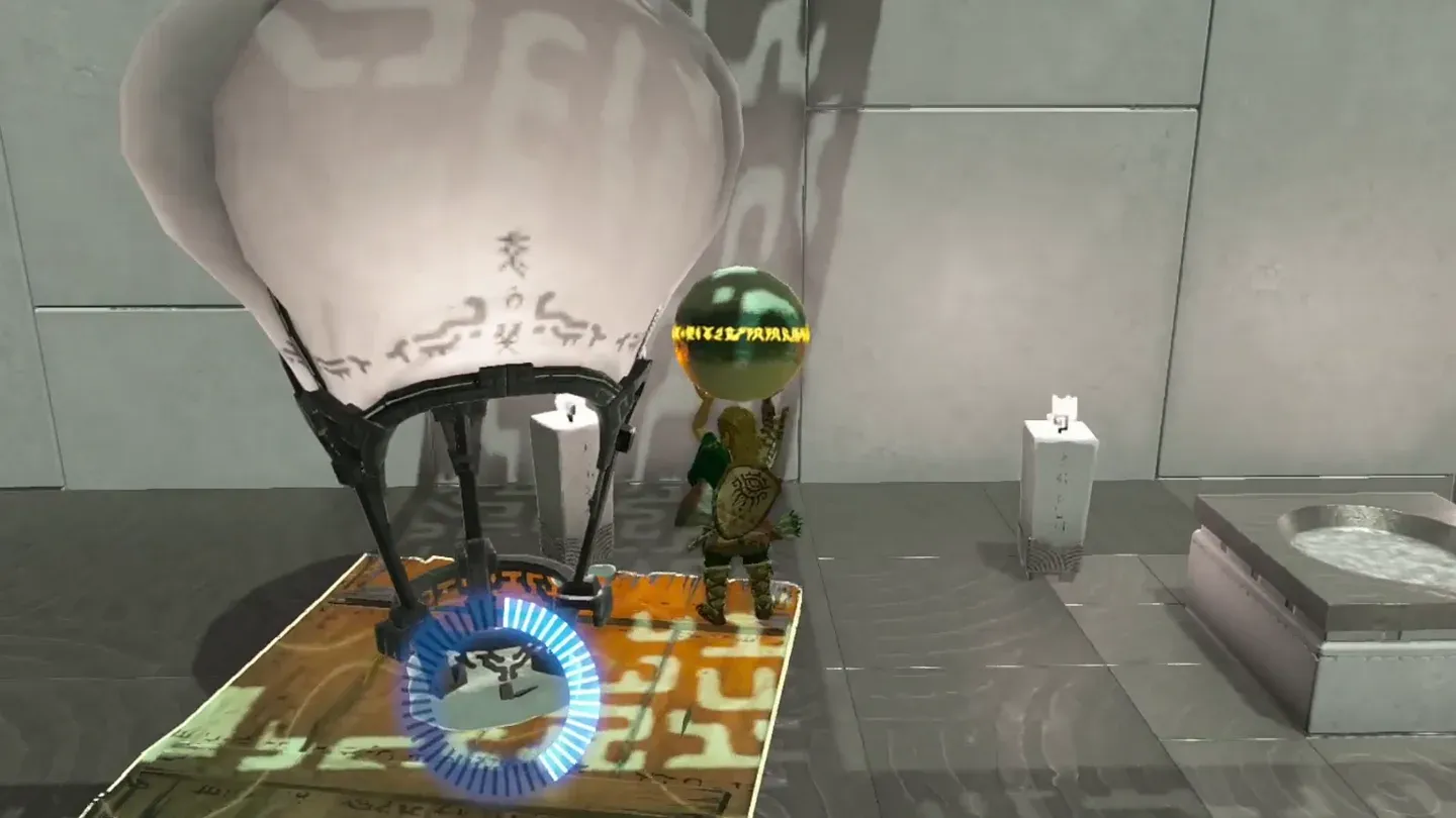 The small orb stacked on the big orb with a balloon attached on top