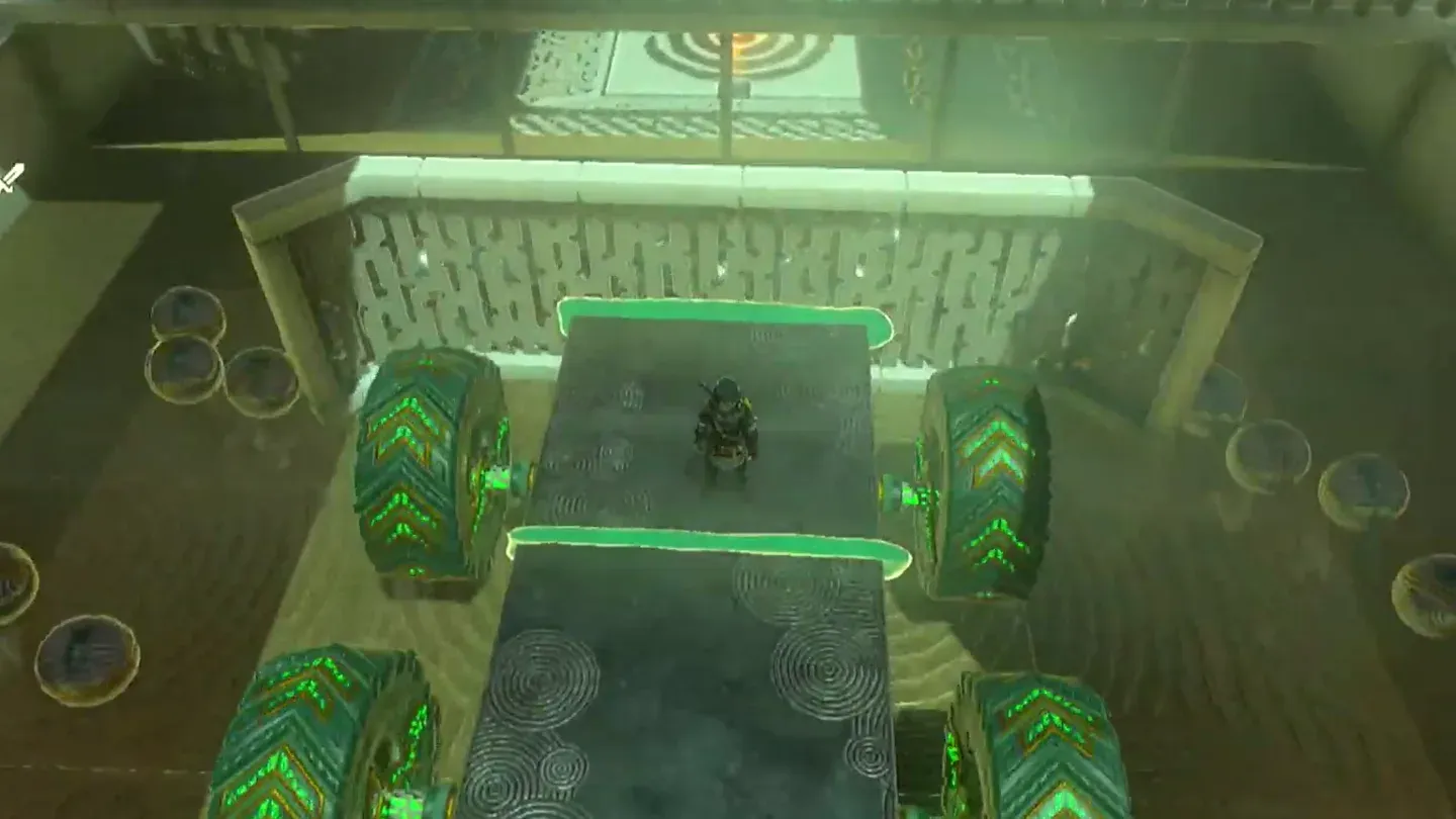 The scoop cart rolling toward the small metal balls and the switch