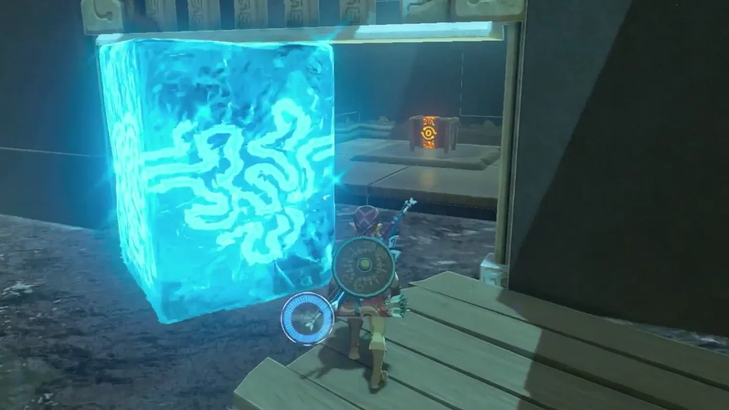 The gate pushed up by an ice block, a treasure chest visible behind it