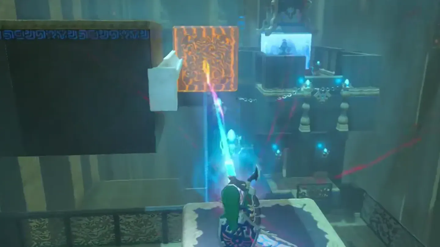 Link pushing the big metal cube with Magnesis from the moving platform