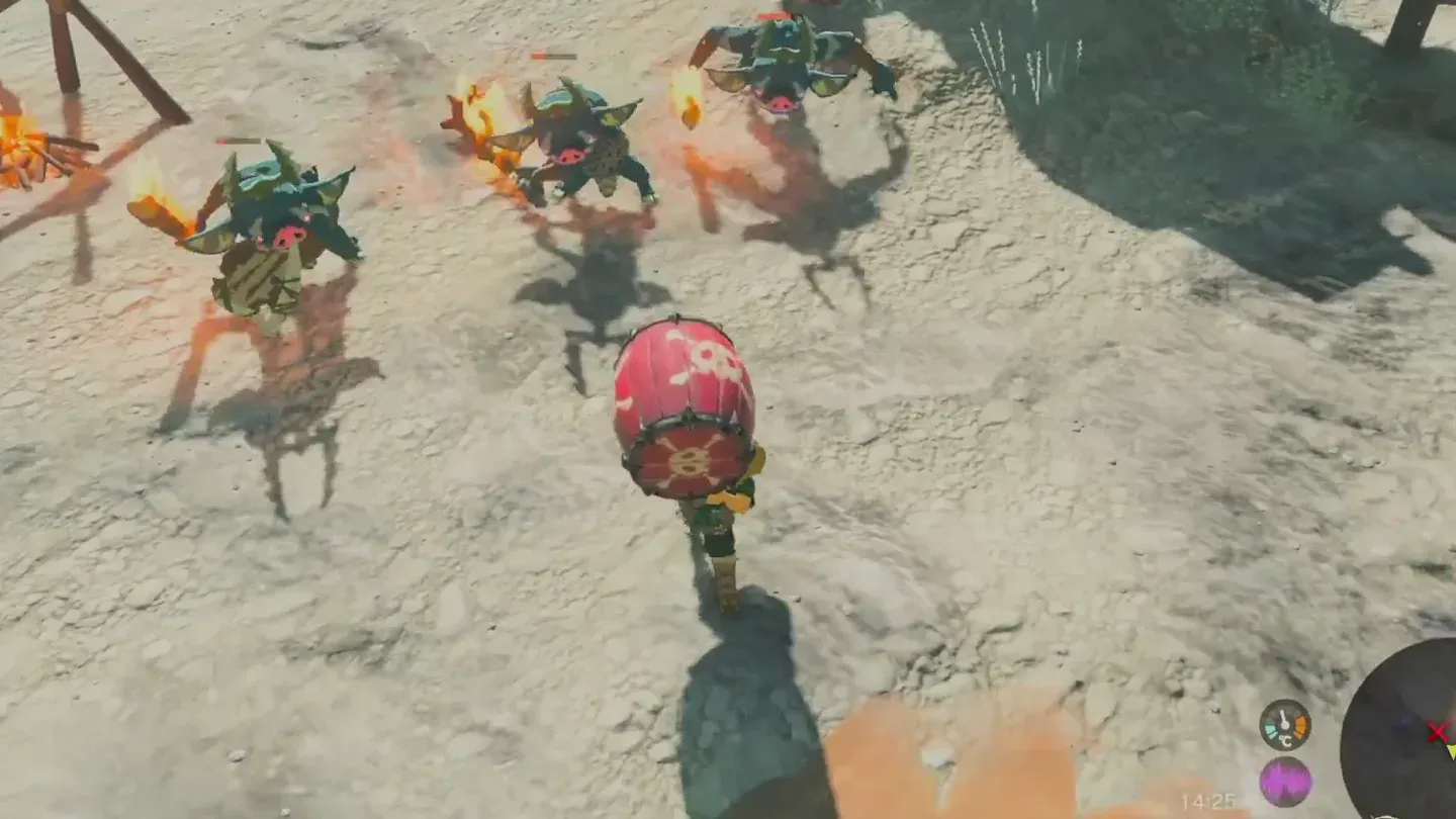 Link carrying a red explosive barrel toward a group of Bokoblins