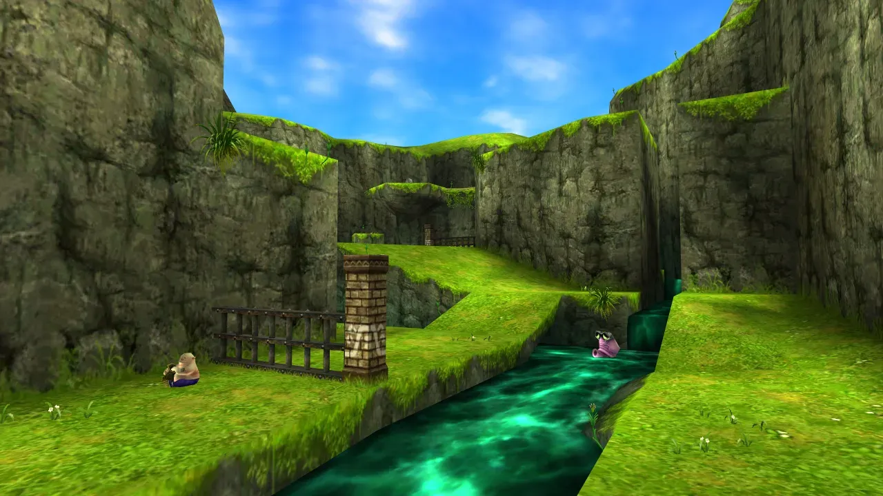 The entrance to Zora's River under a blue sky, with the Bean Seller sitting on the grass beside a wooden fence on the left bank