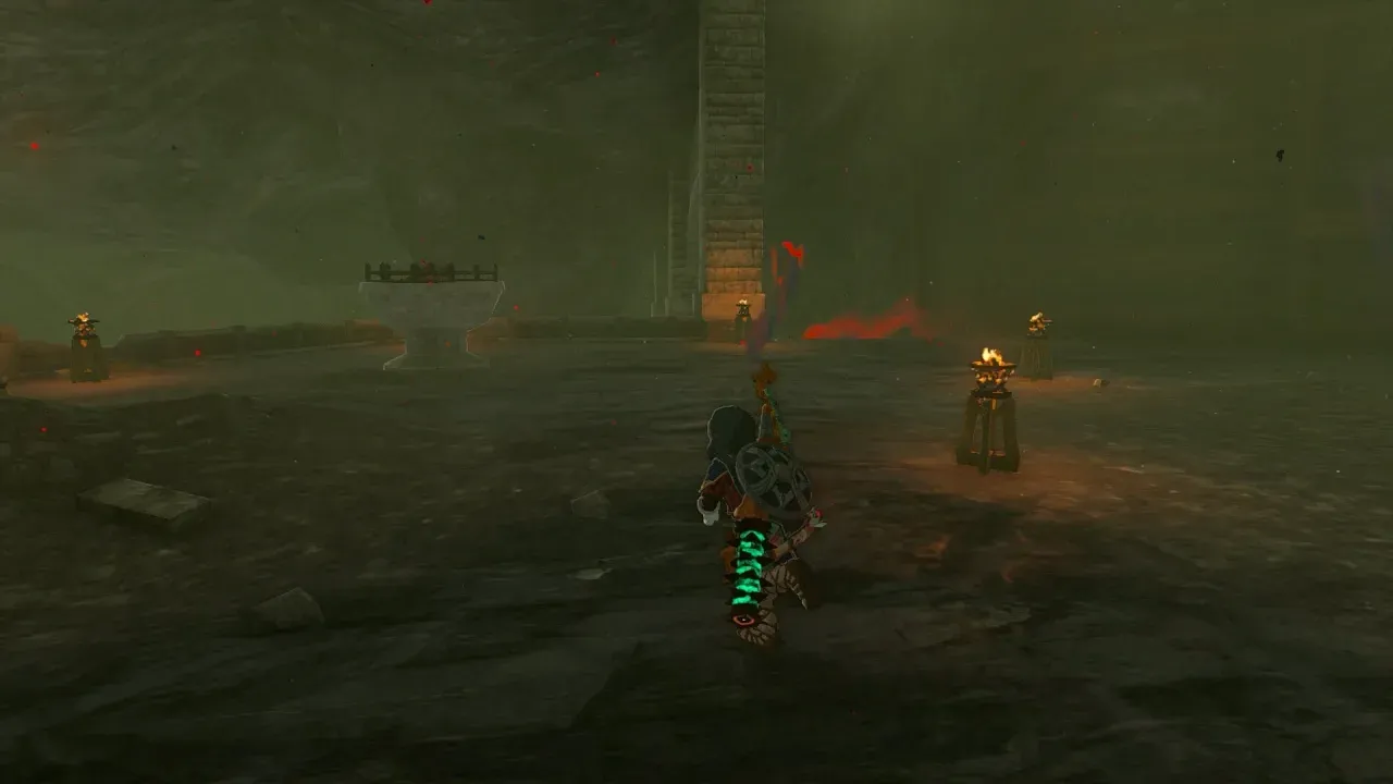Link running toward a large unlit brazier surrounded by small burning torches