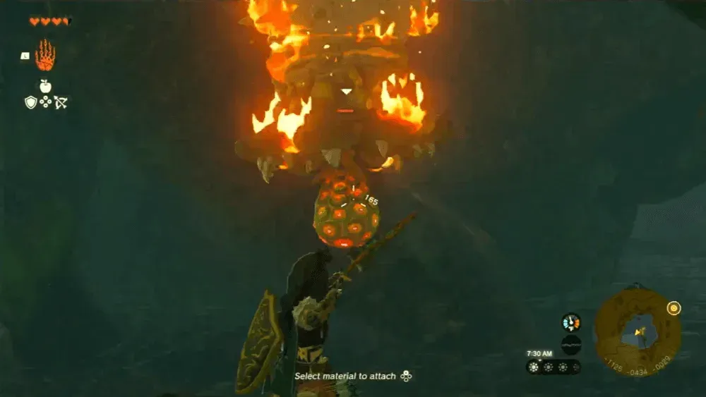 Link aiming a bow at a burning Like Like on a cave ceiling, its round orange-spotted tongue hanging out of the mouth