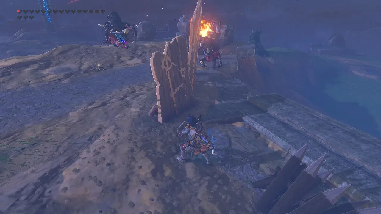 Link behind a wooden barricade facing the Lizalfos camp