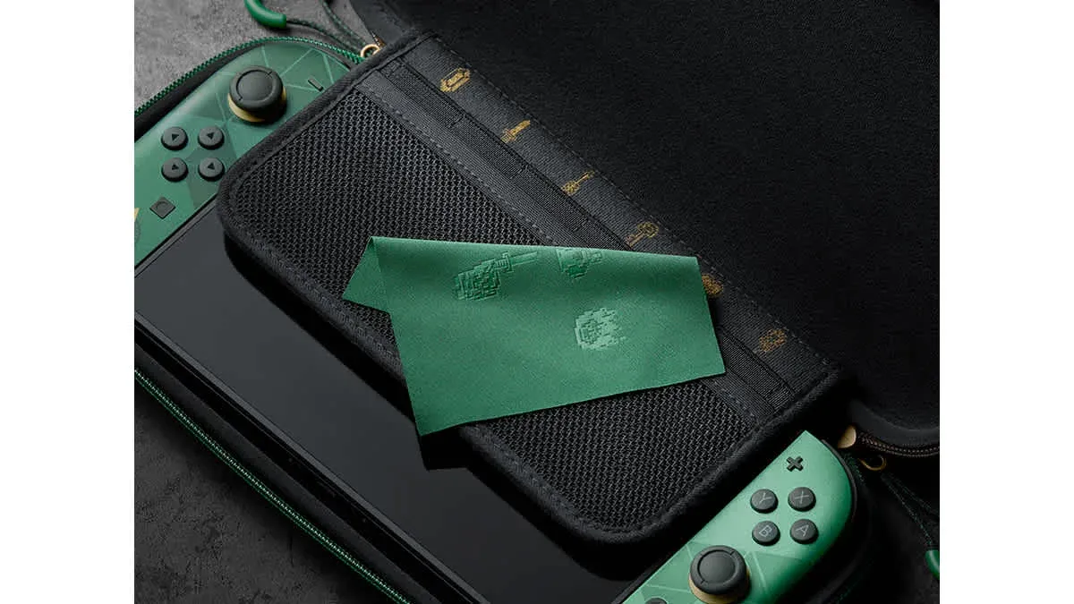 Open Zelda 40th Anniversary carrying case with a Switch 2 inside and a green cleaning cloth with pixel art