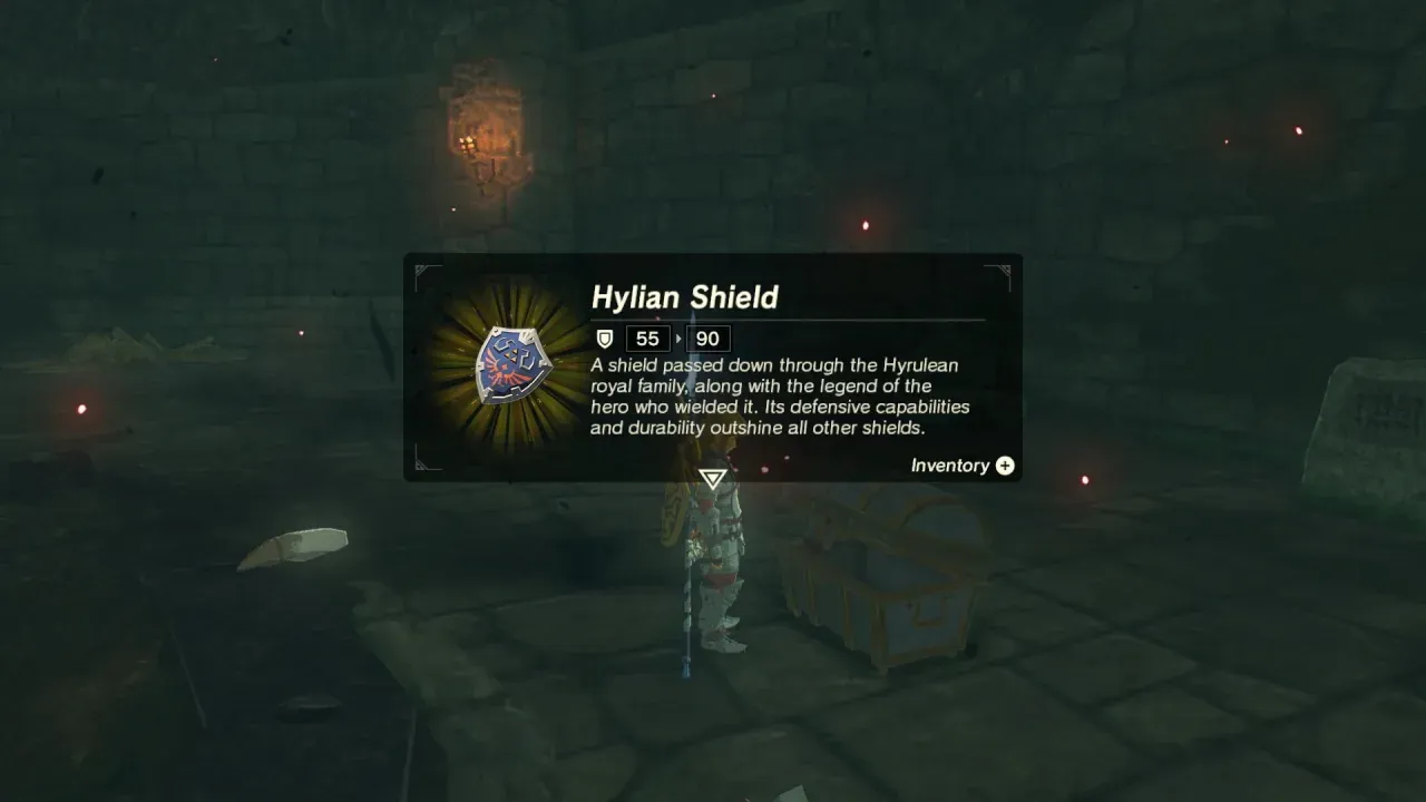 Item card for the Hylian Shield showing guard 90, beside the opened chest