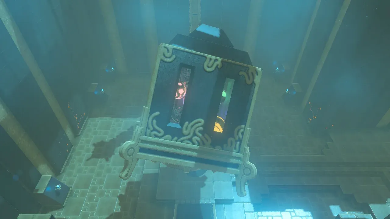 The suspended box containing the coloured balls