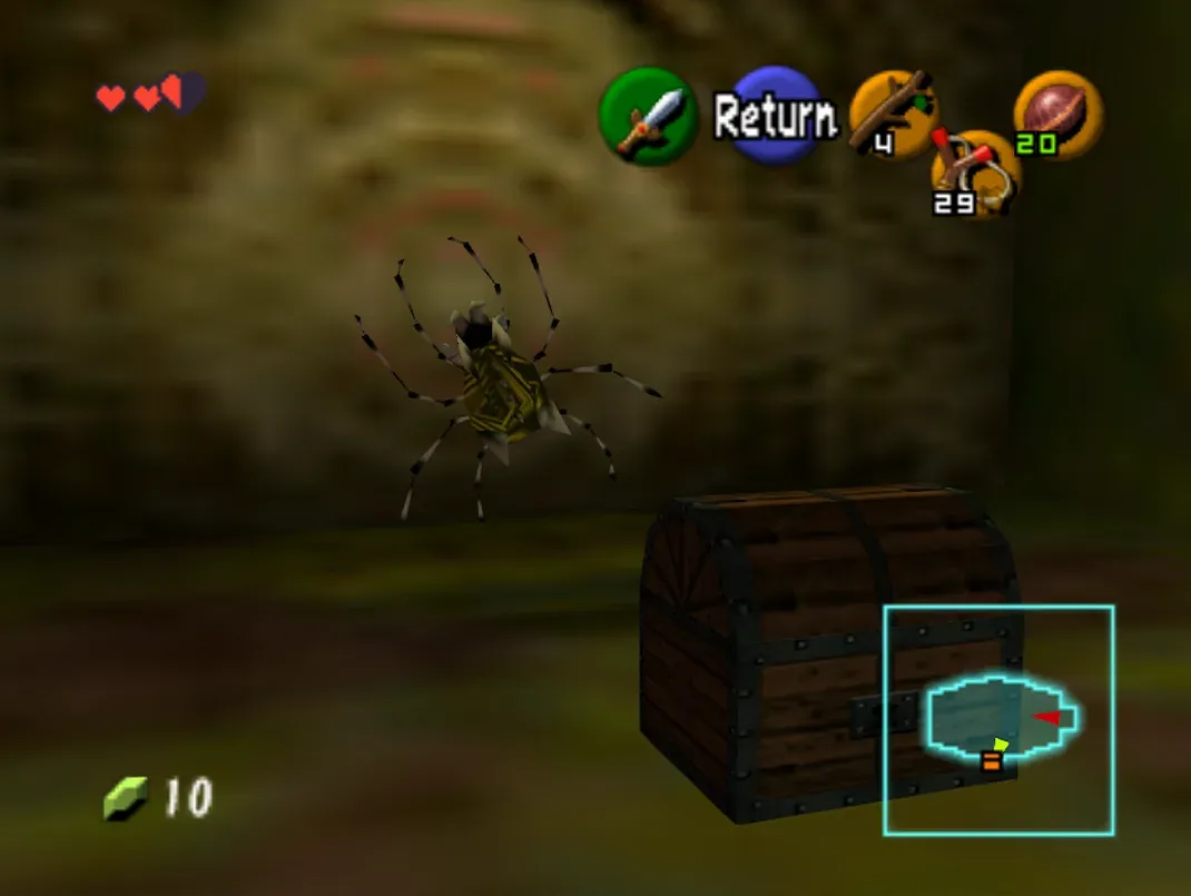 A Gold Skulltula beside a small chest inside the Deku Tree, N64 version