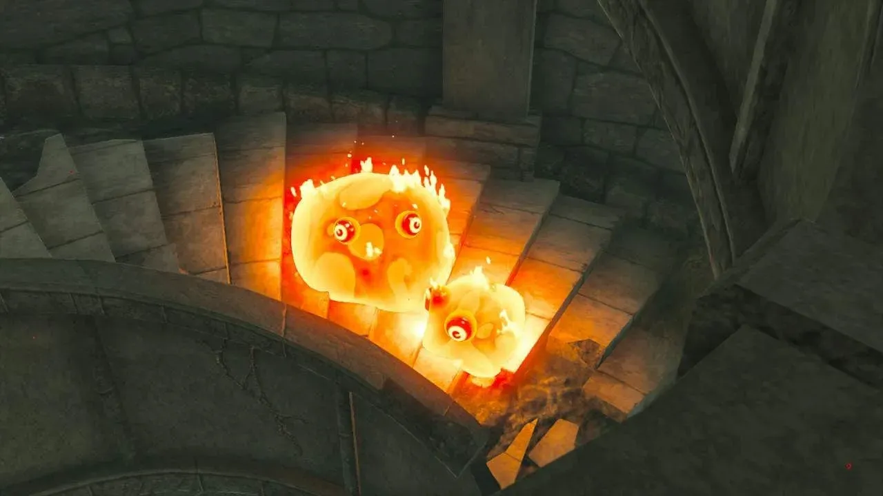 A large and a small Fire Chuchu, both wrapped in flames, on a stone staircase