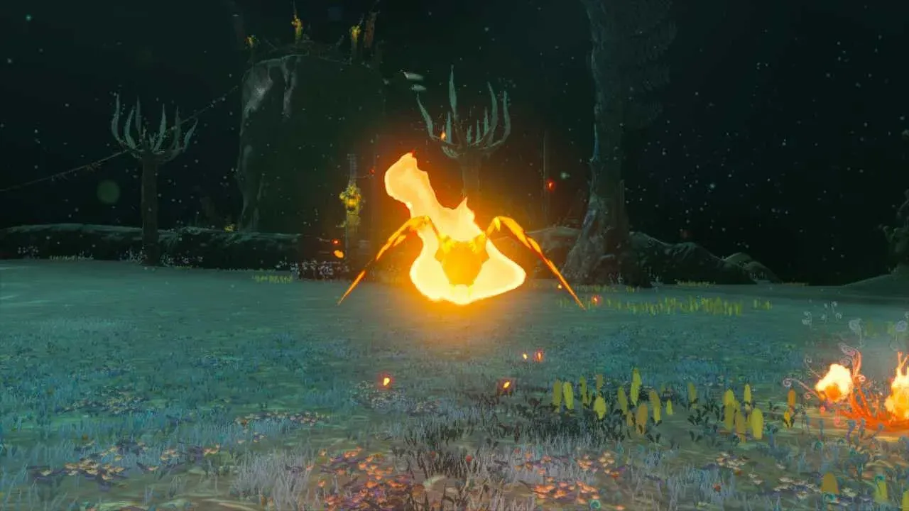 A Fire Keese wrapped in bright orange flames in a dark open area of the Depths