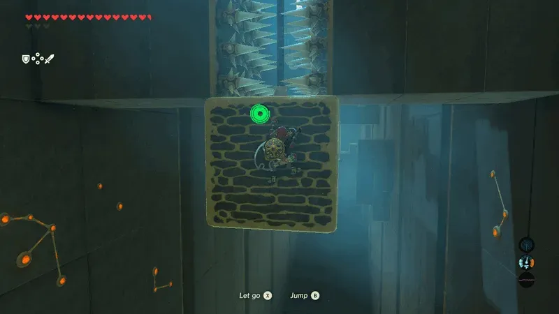 Link clinging low on a hanging block to clear a spiked pillar