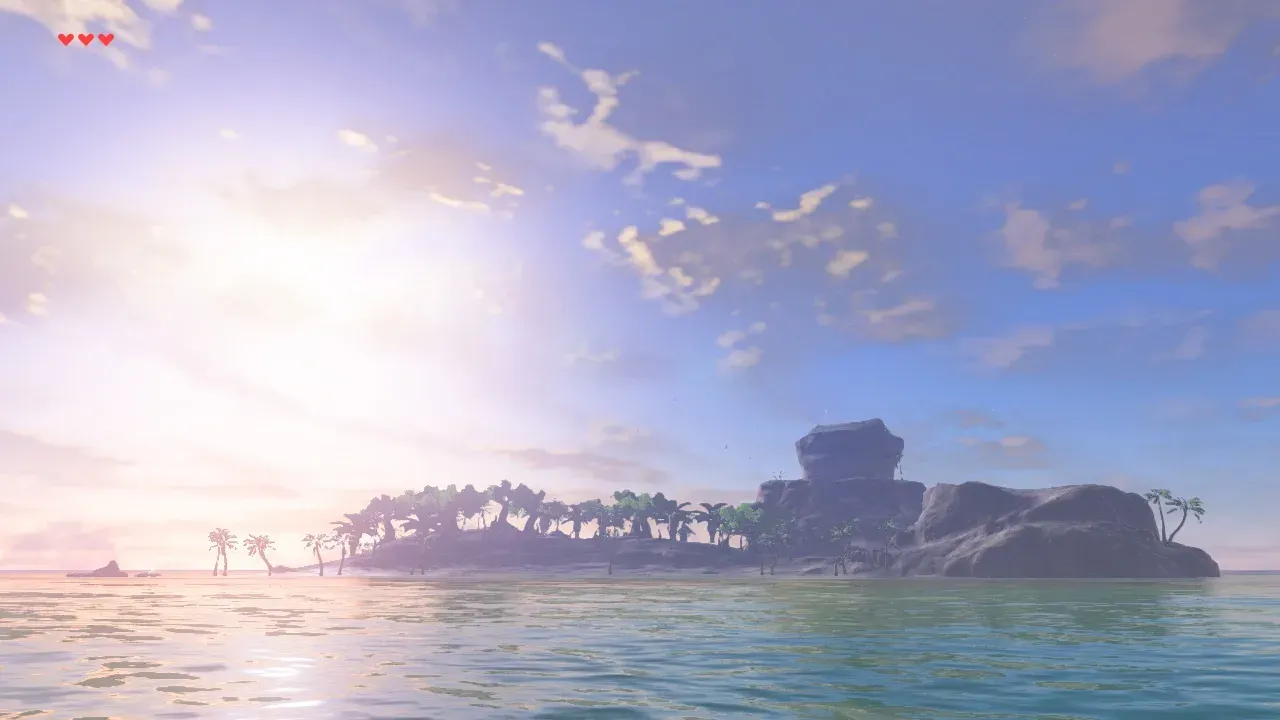 Eventide Island seen from the sea, a palm-lined beach with a tall rock plateau on the right