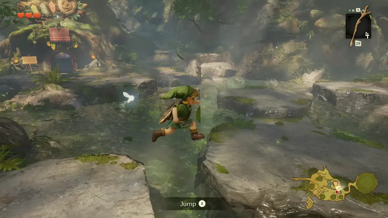 Young Link leaping across a gap over a stream in Kokiri Forest with a Jump prompt on screen
