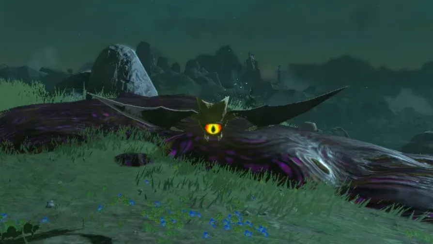 A dark Keese with spread wings and one large orange eye hovering over grass at night