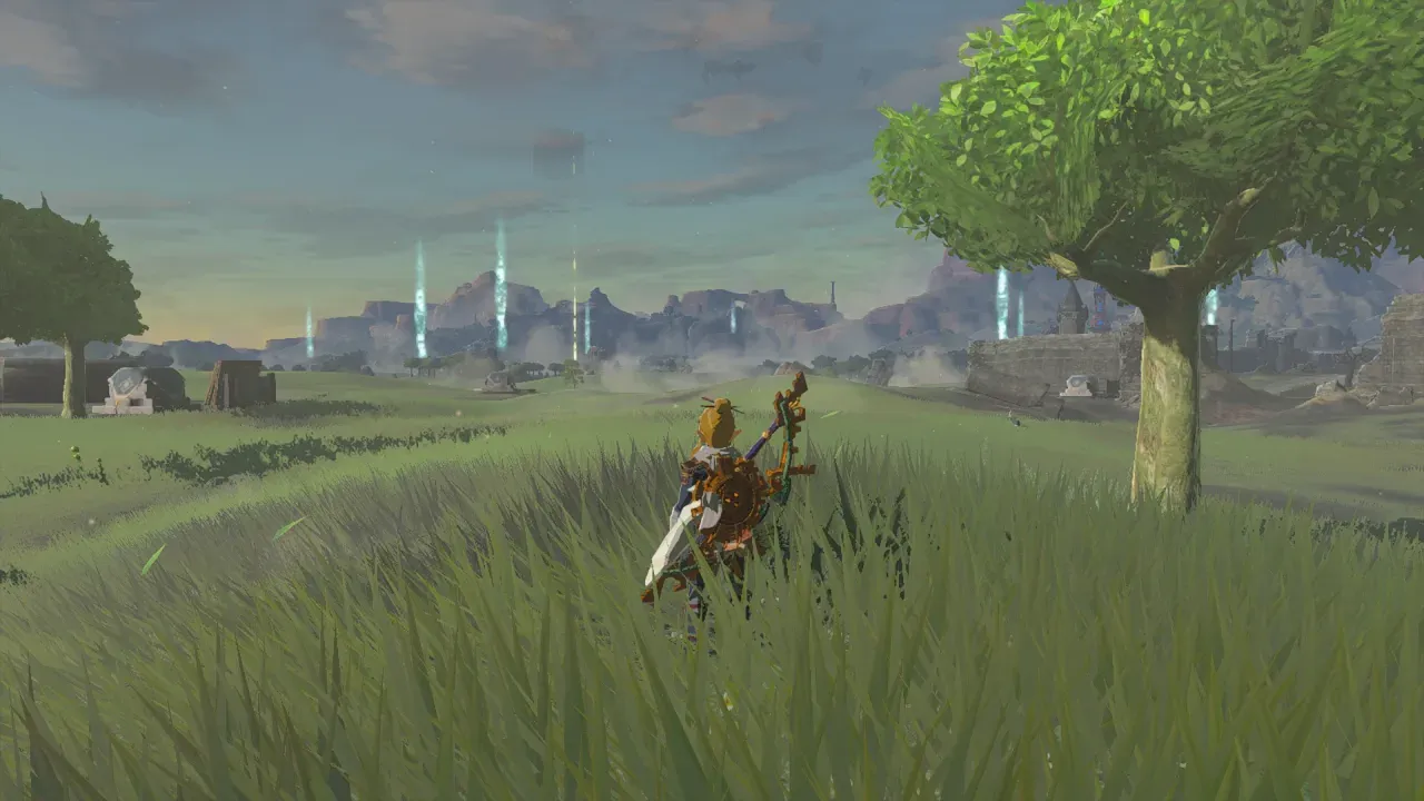 Link standing in a field with several thin pillars of light rising at the foot of distant hills