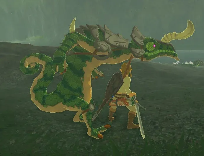 A green Lizalfos with a curved horn standing over Link on a dark grassy shore