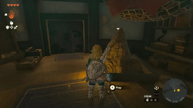 Inside Lookout Landing, Link praying at the half-buried head of a Bargainer Statue