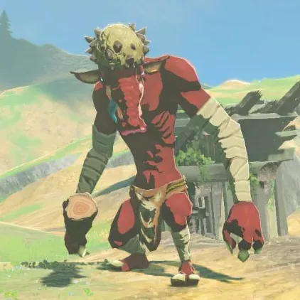 A red Moblin with a spiked bone growth on its head walking toward the camera on a dirt path